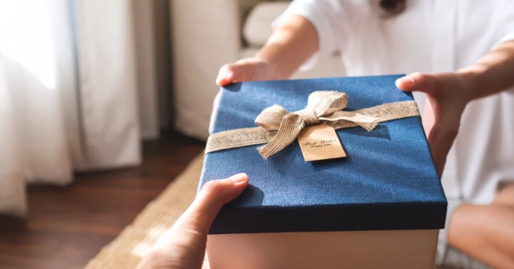 Close-up image of a young couple giving and receiving a gift box to each other