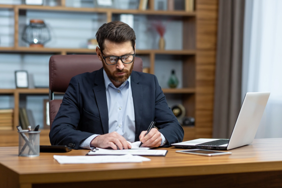 Will writer sitting at his desk writing a will